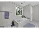 Elegant bathroom featuring a soaking tub and a stained glass window at 392 Hightower Ridge Rd, Covington, GA 30014