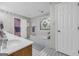 Bright bathroom featuring a white vanity and a soaking tub with stained glass window at 392 Hightower Ridge Rd, Covington, GA 30014