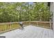 Deck with grill and wooden rails looking out onto backyard wooded area at 392 Hightower Ridge Rd, Covington, GA 30014