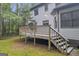 A well-maintained deck offers an inviting outdoor living space with stairs leading to the lush backyard at 392 Hightower Ridge Rd, Covington, GA 30014