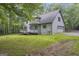 Exterior view of a home featuring a deck, attached garage, and spacious yard backing onto wooded area at 392 Hightower Ridge Rd, Covington, GA 30014