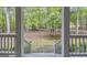 View from covered front porch shows the serene and private natural setting at 392 Hightower Ridge Rd, Covington, GA 30014