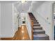 Inviting hallway with hardwood floors leads to the kitchen and a carpeted staircase at 392 Hightower Ridge Rd, Covington, GA 30014