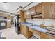 Eat-in kitchen boasts ample counter space, wood cabinets, and a black refrigerator at 392 Hightower Ridge Rd, Covington, GA 30014