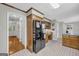 Spacious kitchen featuring wood cabinets, black appliances and gray tile flooring at 392 Hightower Ridge Rd, Covington, GA 30014