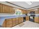 Traditional kitchen featuring wood cabinets, blue countertops, and black appliances at 392 Hightower Ridge Rd, Covington, GA 30014