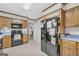 Functional kitchen with oak cabinets, black appliances, and blue countertops at 392 Hightower Ridge Rd, Covington, GA 30014