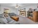 Cozy living room featuring a fireplace, ceiling fan, and plush gray sectional sofa at 392 Hightower Ridge Rd, Covington, GA 30014