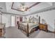 Spacious main bedroom with a decorative wallpaper and a custom tray ceiling at 392 Hightower Ridge Rd, Covington, GA 30014