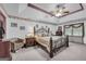 Elegant main bedroom with trey ceiling, decorative wallpaper, and a large window at 392 Hightower Ridge Rd, Covington, GA 30014