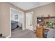 Functional office space featuring a wooden desk and view into the living room at 392 Hightower Ridge Rd, Covington, GA 30014
