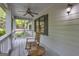 Relaxing side porch featuring a rocking chair and a ceiling fan at 392 Hightower Ridge Rd, Covington, GA 30014