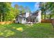 A lush, expansive backyard features patio seating and is fully fenced, offering privacy and space for outdoor enjoyment at 111 Rosignol Dr, Sharpsburg, GA 30277
