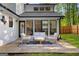 A cozy patio seating arrangement on a patterned rug in a well-maintained backyard is great for outdoor relaxation at 111 Rosignol Dr, Sharpsburg, GA 30277
