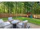 A beautiful backyard has a playhouse, surrounded by a wood fence, perfect for Gathering fun at 111 Rosignol Dr, Sharpsburg, GA 30277