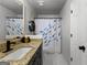 Bathroom featuring vanity with granite counters and blue and yellow fish themed shower curtain at 111 Rosignol Dr, Sharpsburg, GA 30277