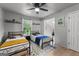 Inviting bedroom with twin beds, a ceiling fan, and natural light from the window at 111 Rosignol Dr, Sharpsburg, GA 30277
