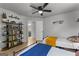 Bedroom featuring two twin beds, ceiling fan, and a stylish bookshelf at 111 Rosignol Dr, Sharpsburg, GA 30277