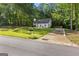 Well-maintained property with lush green lawn, mature trees, and a long paved driveway at 111 Rosignol Dr, Sharpsburg, GA 30277