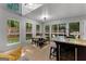 Eat-in kitchen features table with seating, stainless appliances, an island with bar stool seating and natural light at 111 Rosignol Dr, Sharpsburg, GA 30277