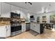 Beautiful kitchen features stainless steel appliances, white cabinets and an island with bar stool seating at 111 Rosignol Dr, Sharpsburg, GA 30277