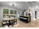 Eat-in kitchen features table with seating, stainless appliances, an island with bar stool seating and natural light at 111 Rosignol Dr, Sharpsburg, GA 30277