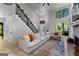 Bright living room with high ceilings, a modern fireplace, and a large sectional couch with colorful pillows at 111 Rosignol Dr, Sharpsburg, GA 30277