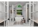 Bright and airy main bathroom with a soaking tub, white tile and stylish fixtures at 111 Rosignol Dr, Sharpsburg, GA 30277