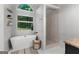 A bright main bathroom features a soaking tub, shower, and decorative shelves at 111 Rosignol Dr, Sharpsburg, GA 30277