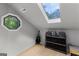 Bright playroom area with skylight, guitar, shelves with storage bins, and wood flooring at 111 Rosignol Dr, Sharpsburg, GA 30277