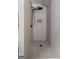 Modern shower with a rainfall shower head, built-in niche, and gray penny tile floor at 111 Rosignol Dr, Sharpsburg, GA 30277