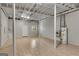 Unfinished basement with new floors, an exposed ceiling, and a hot water heater at 1368 Poplar Se Pointe, Smyrna, GA 30082