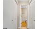 Hallway view of a quaint bathroom with wood floors and neutral-colored walls at 1368 Poplar Se Pointe, Smyrna, GA 30082