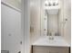 Well-lit bathroom with a single vanity, modern lighting, and neutral wall color at 1368 Poplar Se Pointe, Smyrna, GA 30082