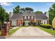 Townhome exteriors with brick facades, well-maintained landscaping, and private driveways at 1368 Poplar Se Pointe, Smyrna, GA 30082