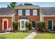 Charming brick townhome with a bay window and colorful front doors at 1368 Poplar Se Pointe, Smyrna, GA 30082