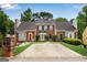 Brick townhouses featuring a shared driveway, manicured lawns, and inviting curb appeal at 1368 Poplar Se Pointe, Smyrna, GA 30082