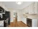 Kitchen with stainless steel appliances, white cabinetry, and wood floors at 1368 Poplar Se Pointe, Smyrna, GA 30082