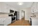 Modern kitchen with white cabinets, stainless steel appliances, and wood flooring at 1368 Poplar Se Pointe, Smyrna, GA 30082