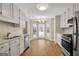 Kitchen showcasing stainless steel appliances, white cabinets, and wood flooring at 1368 Poplar Se Pointe, Smyrna, GA 30082