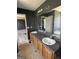 Bright bathroom features a double vanity with a large mirror and natural light at 132 Scarlett Place Dr, Bowdon, GA 30108