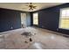 Bright bedroom with two windows, ceiling fan, and neutral walls provides ample natural light at 132 Scarlett Place Dr, Bowdon, GA 30108