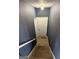 Descending staircase leads to lower level, featuring neutral walls and white trim at 132 Scarlett Place Dr, Bowdon, GA 30108