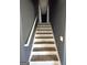 Ascending staircase with white risers and handrail leads to upper level, featuring neutral wall paint at 132 Scarlett Place Dr, Bowdon, GA 30108