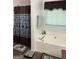 Bathroom featuring a soaking tub, patterned shower curtain, window, tile floors, and a set of towels at 1432 Eagles Nest Cir, Carrollton, GA 30116