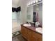 Bathroom showcasing double sinks, wooden cabinets, decorative mirror, and a soaking tub at 1432 Eagles Nest Cir, Carrollton, GA 30116