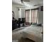 This bedroom features a bed, dresser, television, and window with curtains at 1432 Eagles Nest Cir, Carrollton, GA 30116