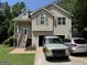 Charming two-story home with attached garage, complemented by a well-maintained lawn and driveway at 1432 Eagles Nest Cir, Carrollton, GA 30116