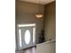 The foyer features a white front door with sidelights and a decorative transom window, plus an elegant light fixture at 1432 Eagles Nest Cir, Carrollton, GA 30116