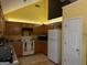 Functional kitchen featuring wood cabinets, white appliances, and great storage space at 1432 Eagles Nest Cir, Carrollton, GA 30116